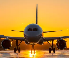 Sunset behind a plane on tarmac